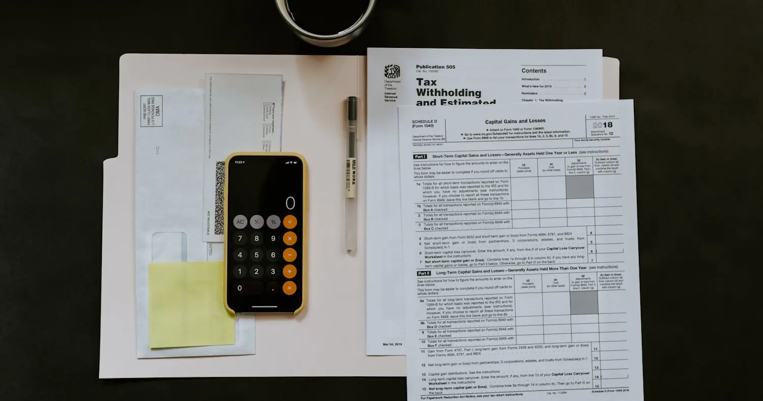 Tax document, pen and smartphone