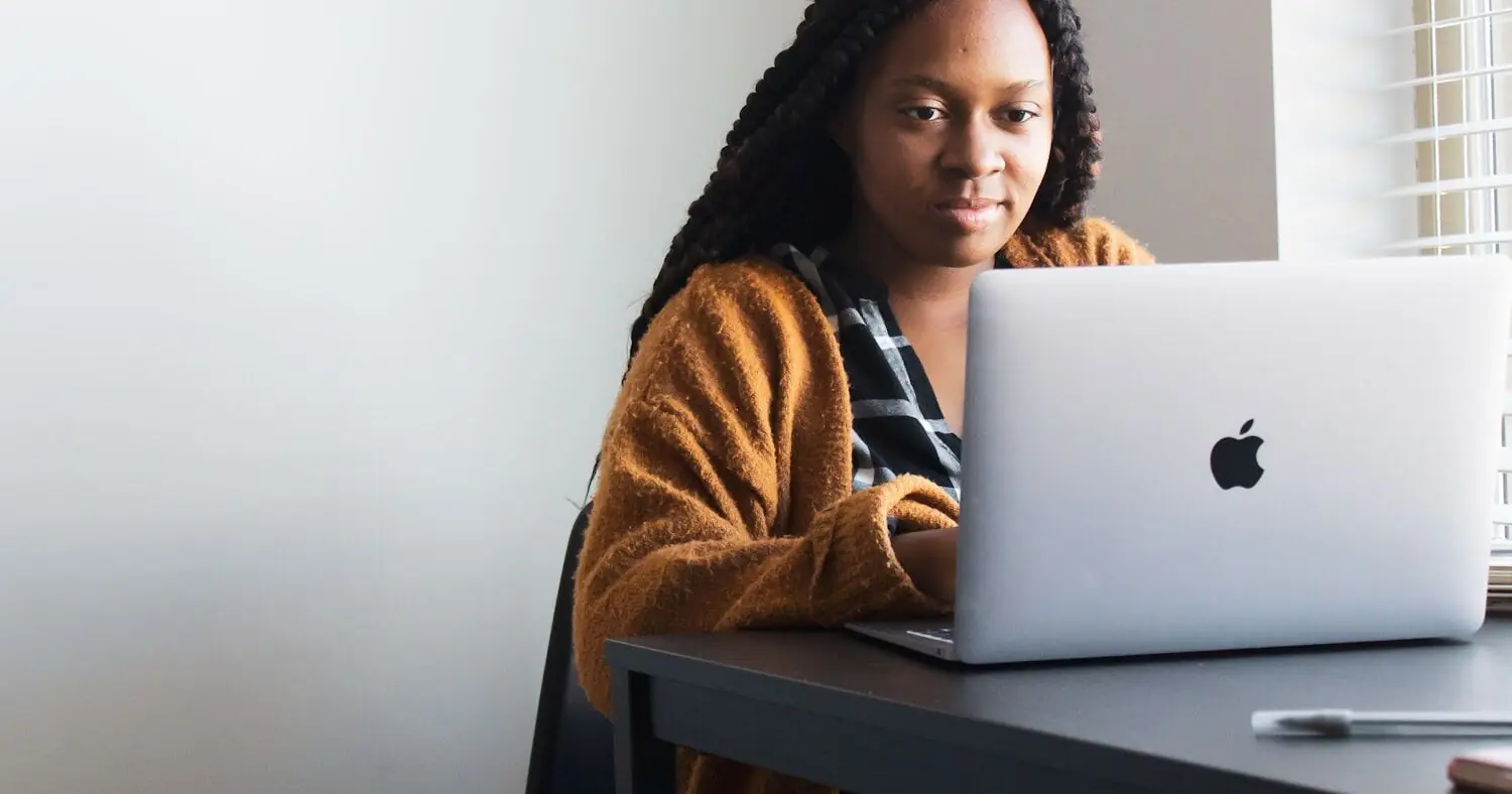 Person filling in an official form on a laptop