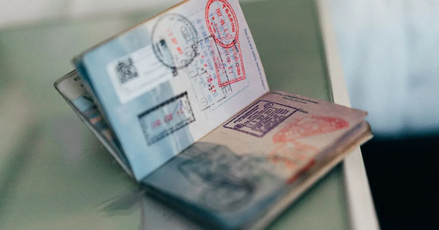 An open passport covered in entry stamps